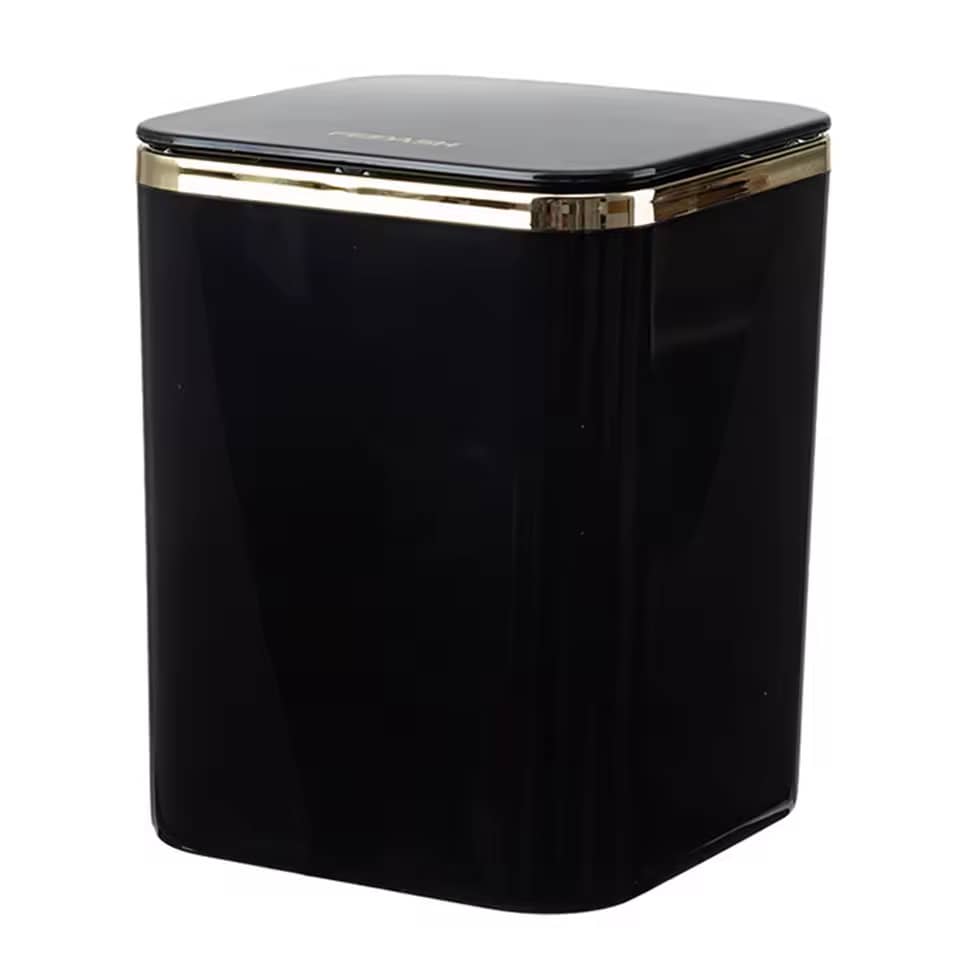 Glossy black luxury mini desktop trash can with polished gold trim accent on white background
