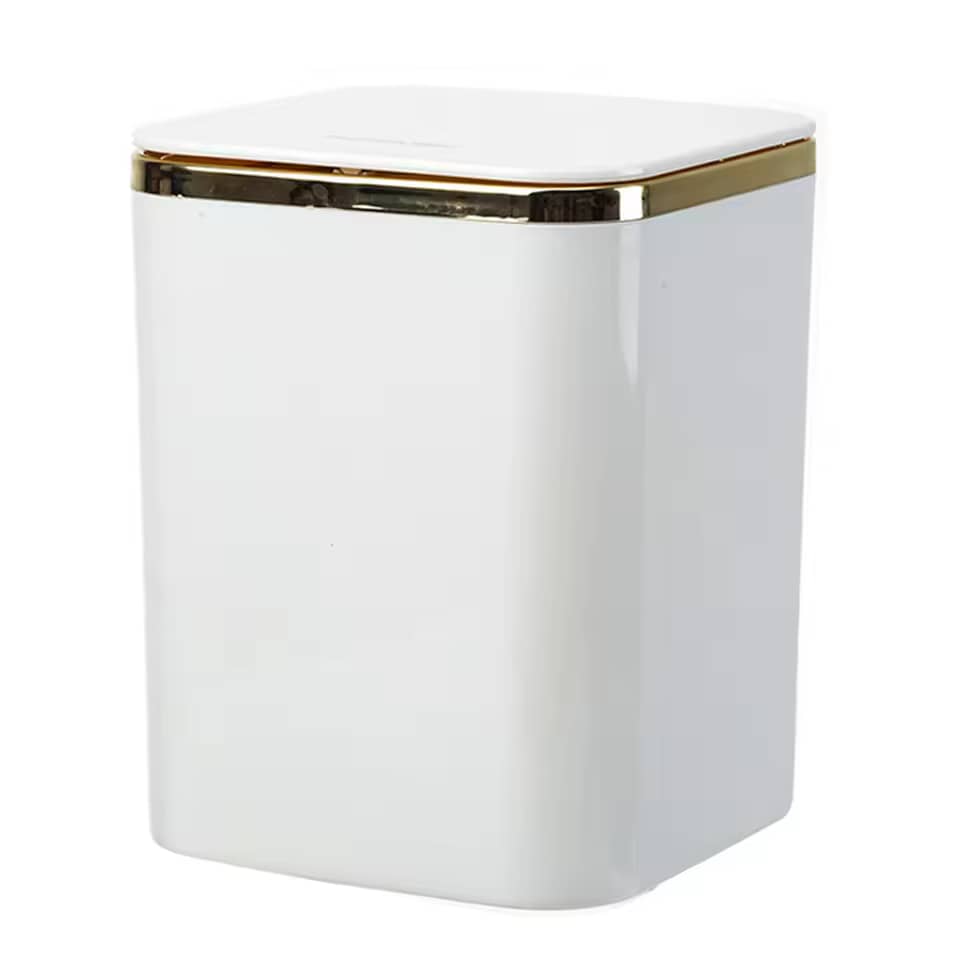 Glossy white mini luxury trash can with gold trim on clean white background studio shot
